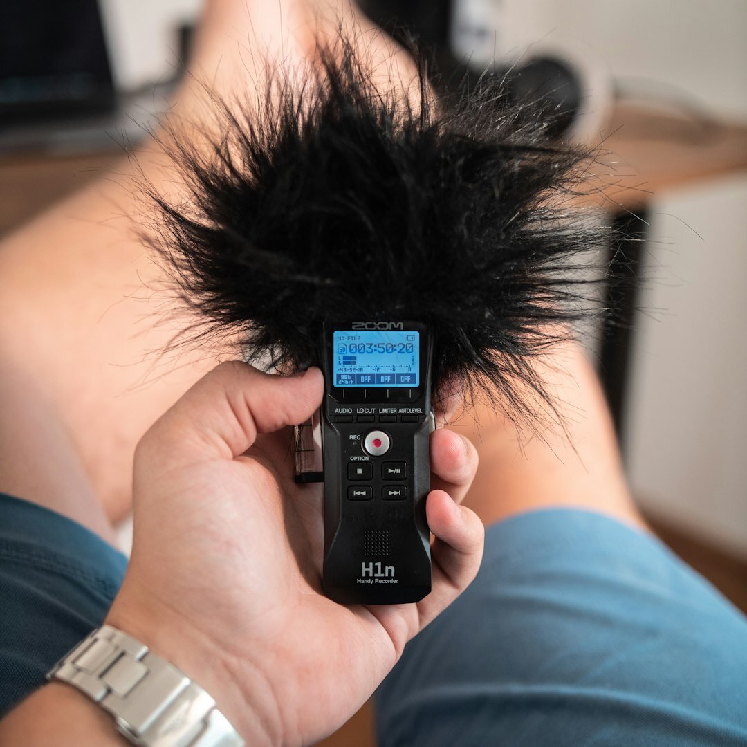 Sound technician with boom microphone recording audio during training